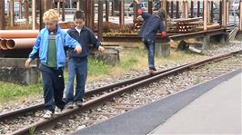 Tao catches one of the rail-walkers falling off the rail